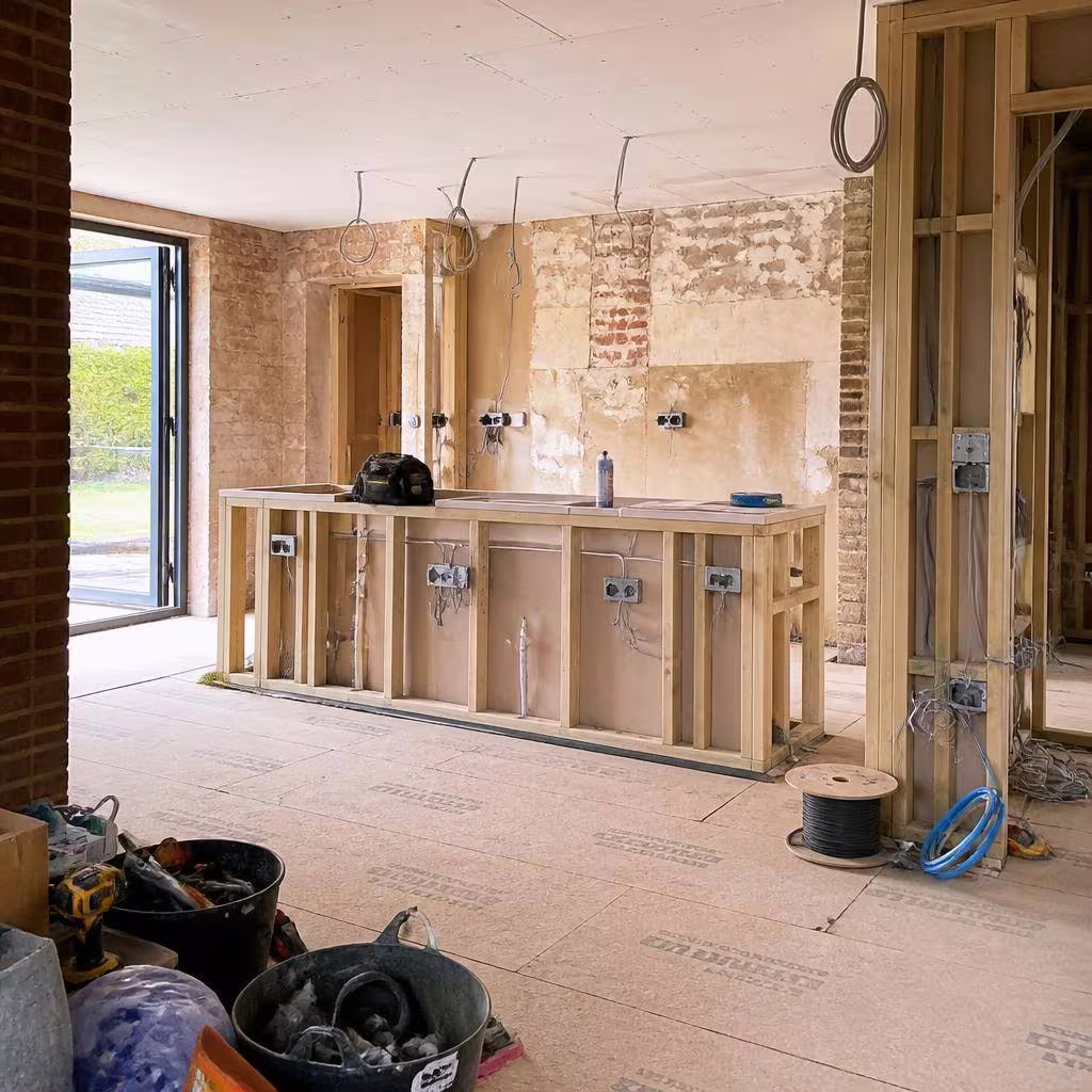 Kitchen extension under construction with exposed brick and first fix wiring